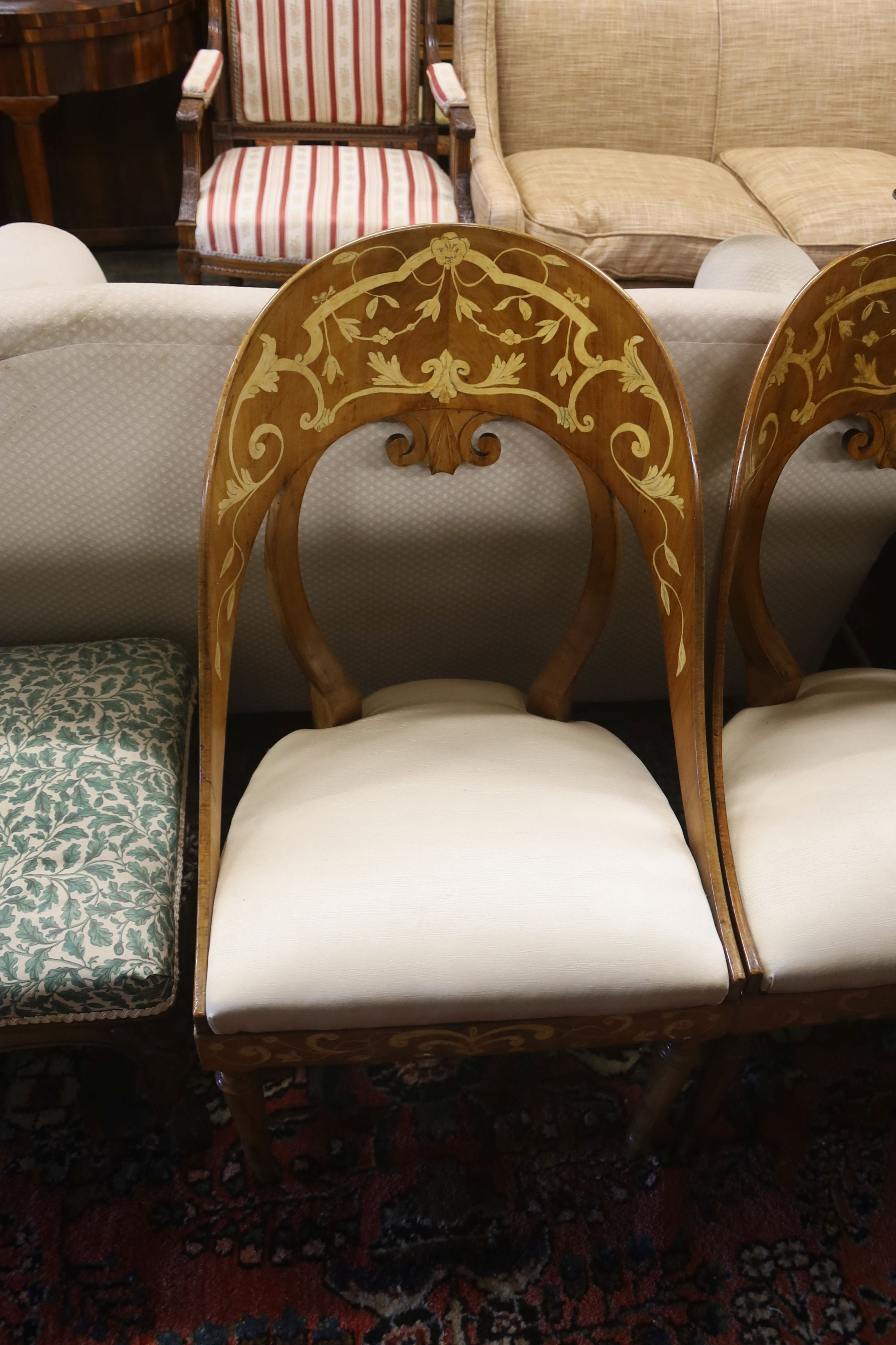 A pair of Italian walnut marquetry inlaid chairs, width 48cm, depth 40cm, height 90cm